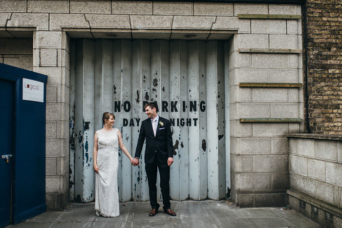 bride and groom at front of old gate in Dublin