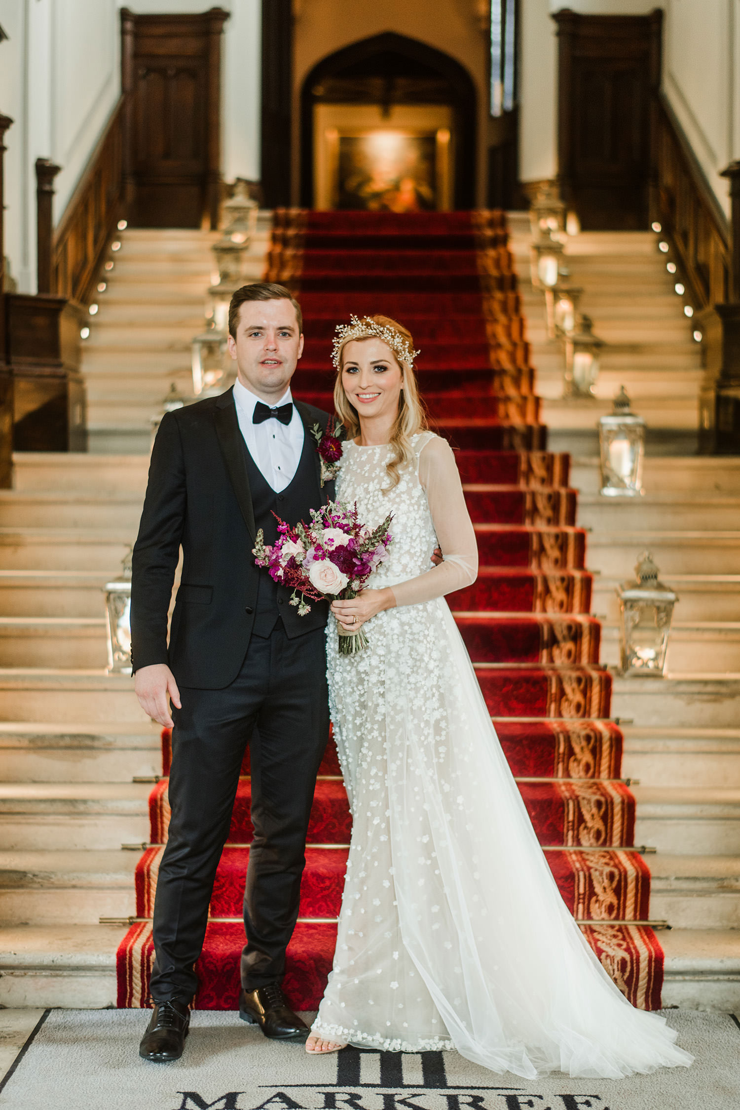 bride and groom on main stairs inside markree castle